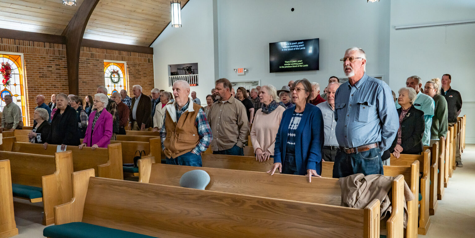 The Riverside congregation standing and singing a hymn in the church sanctuary