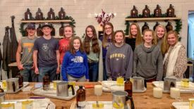 Students making candles for widows/widowers of the church