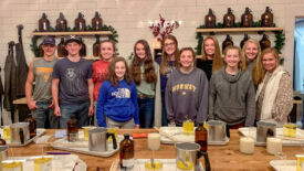 Students making candles for widows/widowers of the church