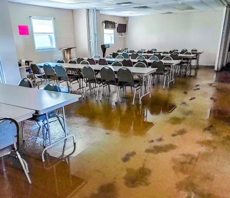 The muddy Fellowship Hall after the flood